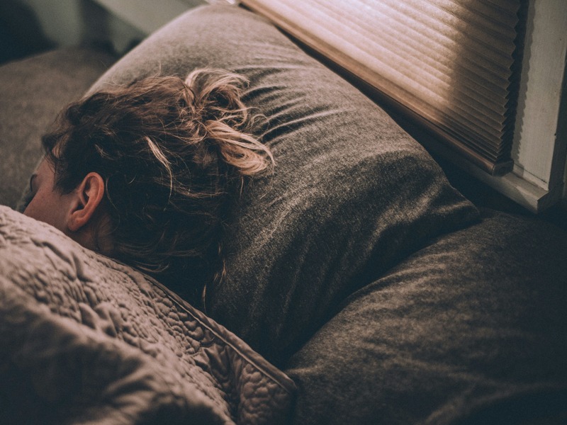 Woman sleeping peacefully on bed